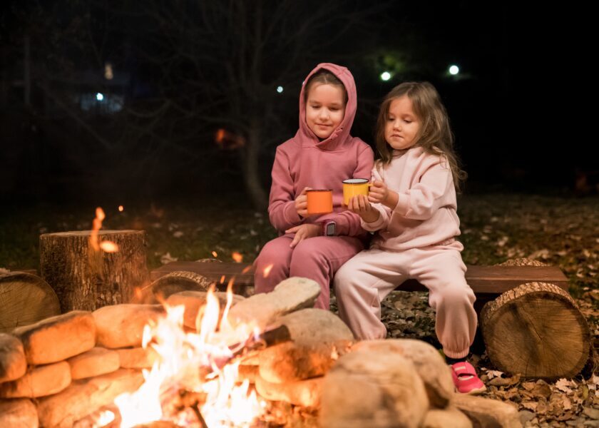 fun-camping-activities-for-kids-girls-sitting-by-2022-03-06-20-18-19-utc