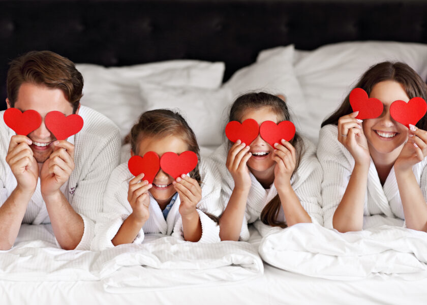 Happy family relaxing in hotel room